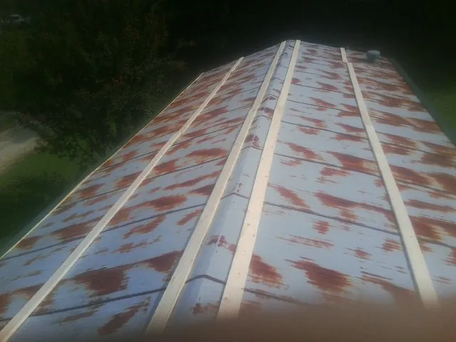 Rusted metal roof panels with new wood purlins before replacement — Storm Damage Roof Repair in Sassamansville by Roofing Brothers